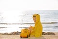 Little cute child baby boy sitting at sea on sand beach, play with toy car truck. Little kid son playing outdoors. Love Royalty Free Stock Photo