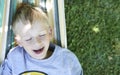 Little cute child blond boy swinging and relaxing on a hammock Royalty Free Stock Photo