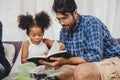 Little cute child looking amaze love to reading book and learn support from dad to smart kid concept Royalty Free Stock Photo