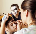 Little cute child making facepaint on birthday party, zombie Apocalypse facepainting, halloween preparing Royalty Free Stock Photo