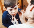 Little cute child making facepaint on birthday party, zombie Apocalypse facepainting, halloween preparing concept Royalty Free Stock Photo