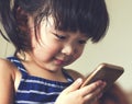 A little cute child playing cell phone device Royalty Free Stock Photo