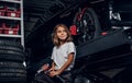 Portrait of cute kid at auto service workshop