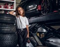 Portrait of cute kid at auto service workshop