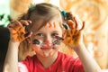 Little cute funny girl artist with paint of the face. Royalty Free Stock Photo
