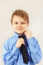 Little cute gentleman tying his over bright shirt Royalty Free Stock Photo