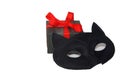 Little cute gift box with bright red ribbon and mysterious eye cat mask, isolated on white background Royalty Free Stock Photo