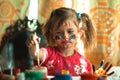 Little cute girl artist with paint of the face. Royalty Free Stock Photo