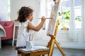 Little cute girl artist painting picture on canvas with watercolor paints at home Royalty Free Stock Photo