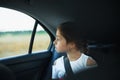 Little Girl in auto baby seat in car looking at window Royalty Free Stock Photo