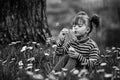 Little cute girl blowing soap bubbles in the park. Black and white photoÃÅ½ Royalty Free Stock Photo