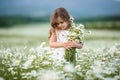 Little cute girl with bouquet of camomile flowers Royalty Free Stock Photo