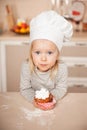 Little cute girl with chef hat holding cake Royalty Free Stock Photo