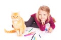 Little cute girl with colored pencils and red cat lying on the floor Royalty Free Stock Photo