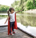 Little cute girl in costume of a super hero