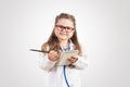 Little cute girl in doctor costume holding sthetoscope on chalkboard.