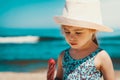 Little and cute girl eating ice cream on the beach Royalty Free Stock Photo