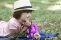 Little cute girl enjoying while lying on grass Royalty Free Stock Photo