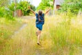 Little cute girl gathers a bouquet of wild flowers on a summer day in the field Royalty Free Stock Photo