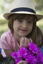 Little cute girl in a hat holding a bouquet of flowers Royalty Free Stock Photo