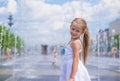 Little cute girl have fun in open street fountain Royalty Free Stock Photo