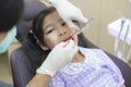 Little cute girl having teeth examined by dentist in dental clinic, teeth check-up and Healthy teeth concept Royalty Free Stock Photo