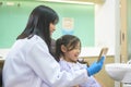 Little cute girl having teeth examined by dentist in dental clinic, teeth check-up and Healthy teeth concept Royalty Free Stock Photo