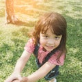 Little cute girl holding hands parents looking at camera