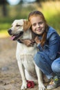 Little cute girl hugs dog (Labrador). Love. Royalty Free Stock Photo