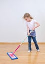 Little cute girl mopping floor.