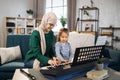 Little cute girl with music muslim teacher having lesson at piano at school of music. Royalty Free Stock Photo