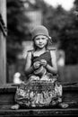 Little cute girl in national dress in the village. Black and white photo. Royalty Free Stock Photo