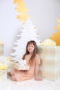 Little cute girl opens a Christmas present. Merry Christmas and happy holidays. New Year 2020. Family holidays. Christmas Eve. Hap Royalty Free Stock Photo