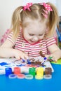 Little cute girl paints with fingers Royalty Free Stock Photo