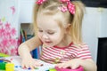 Little cute girl paints with fingers Royalty Free Stock Photo