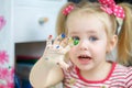 Little cute girl paints with fingers Royalty Free Stock Photo