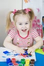 Little cute girl paints with fingers Royalty Free Stock Photo