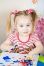 Little cute girl paints with fingers Royalty Free Stock Photo