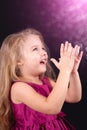 Little cute girl in a pink dress on a black background Royalty Free Stock Photo