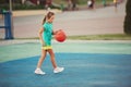 Little cute girl playing basketball outdoors Royalty Free Stock Photo