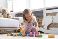 Little cute girl playing block toys in playroom at home. Royalty Free Stock Photo