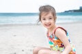 Little cute girl playing in the sand on the beach by the sea Royalty Free Stock Photo