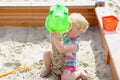 Little cute girl playing in sandbox Royalty Free Stock Photo