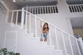 Little cute girl playing on stairs at home Royalty Free Stock Photo