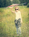 Little cute girl posing with a kite