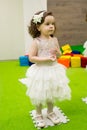 Little cute girl in a puffy dress plays on holiday