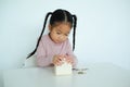 little cute girl putting coin to piggy bank Royalty Free Stock Photo