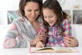 Little cute girl reading book with mother Royalty Free Stock Photo