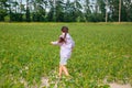 Little cute girl running across the soybean field, summer Royalty Free Stock Photo