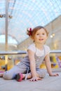 Little cute girl sits on floor and admiringly